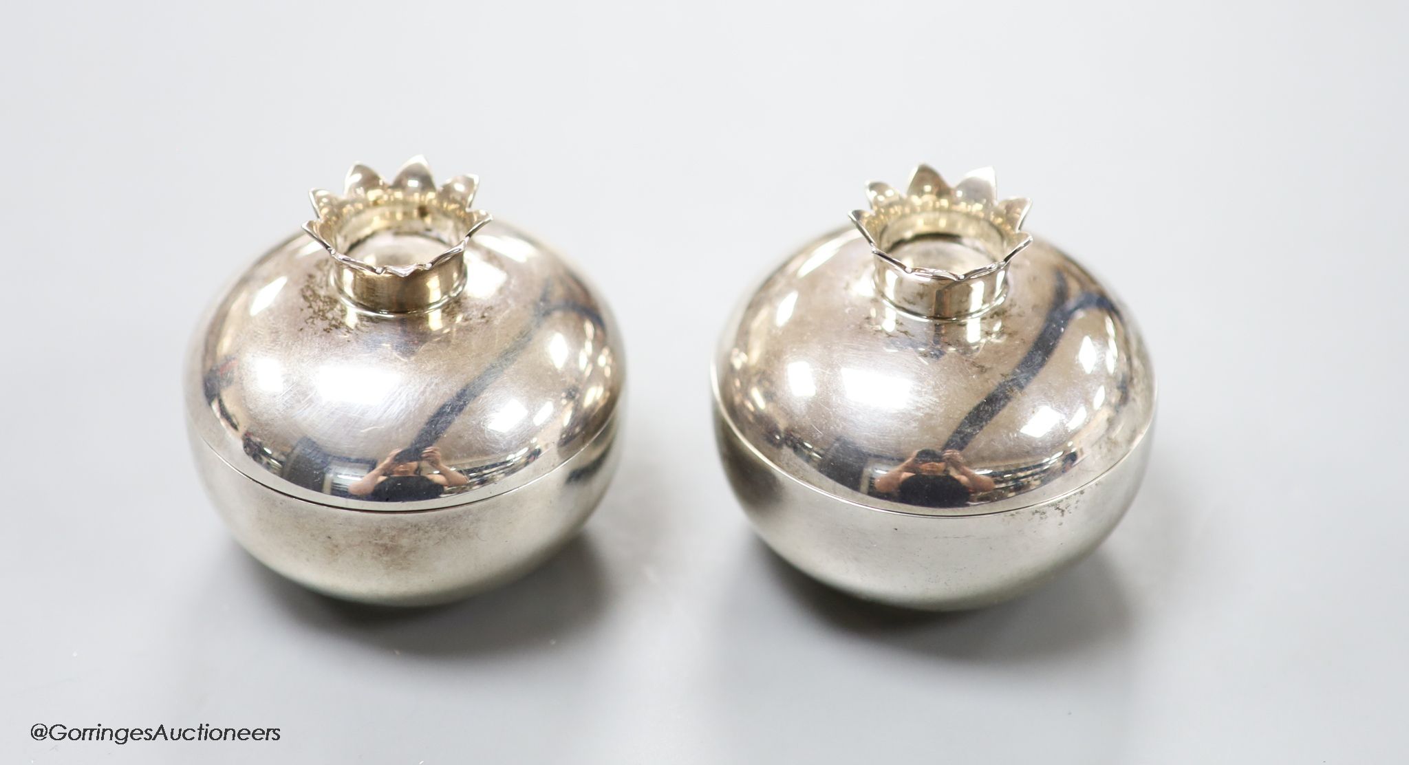 A pair of modern Tiffany & Co small sterling silver circular boxes and covers with crown finials,